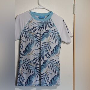 Woman’s Swim Rashguard in Blue and White Tropical Design. In great condition